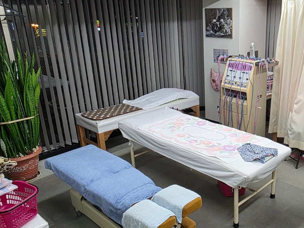 施術ベッドと施術機器のある院内の治療室